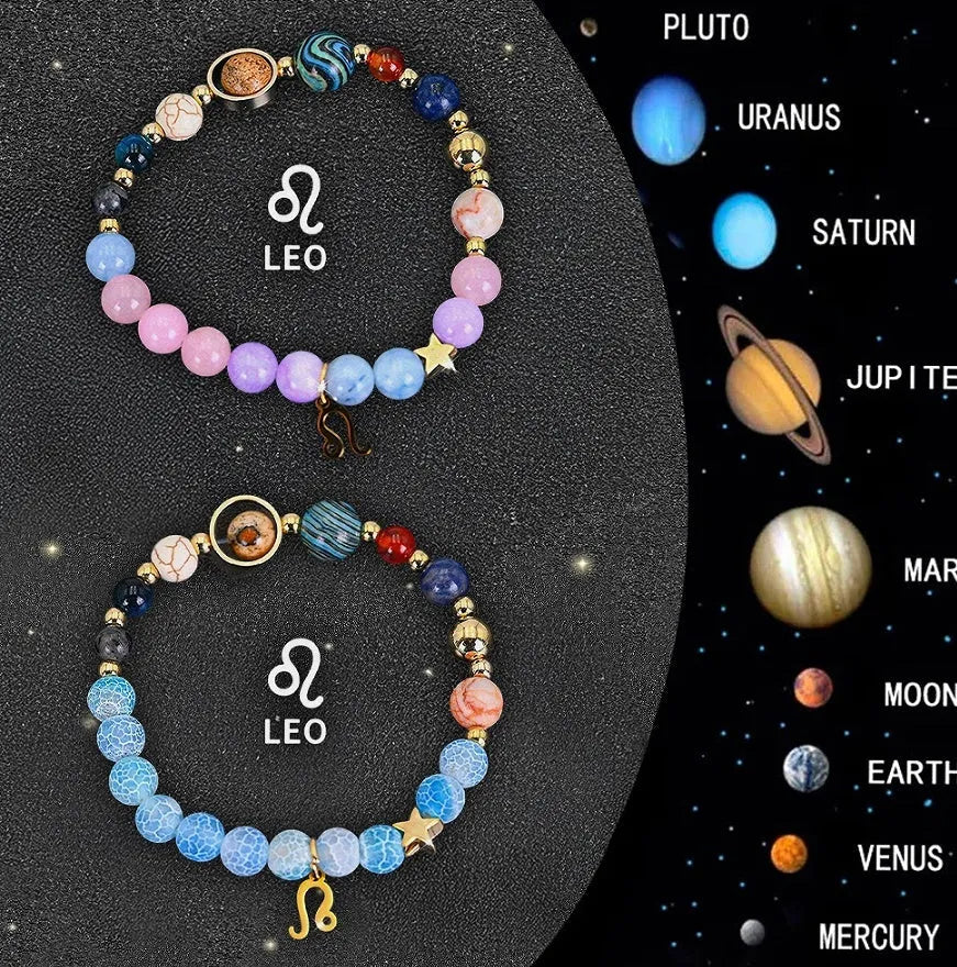 Two natural stone beaded bracelets showing zodiac sign designs on a wooden surface.
