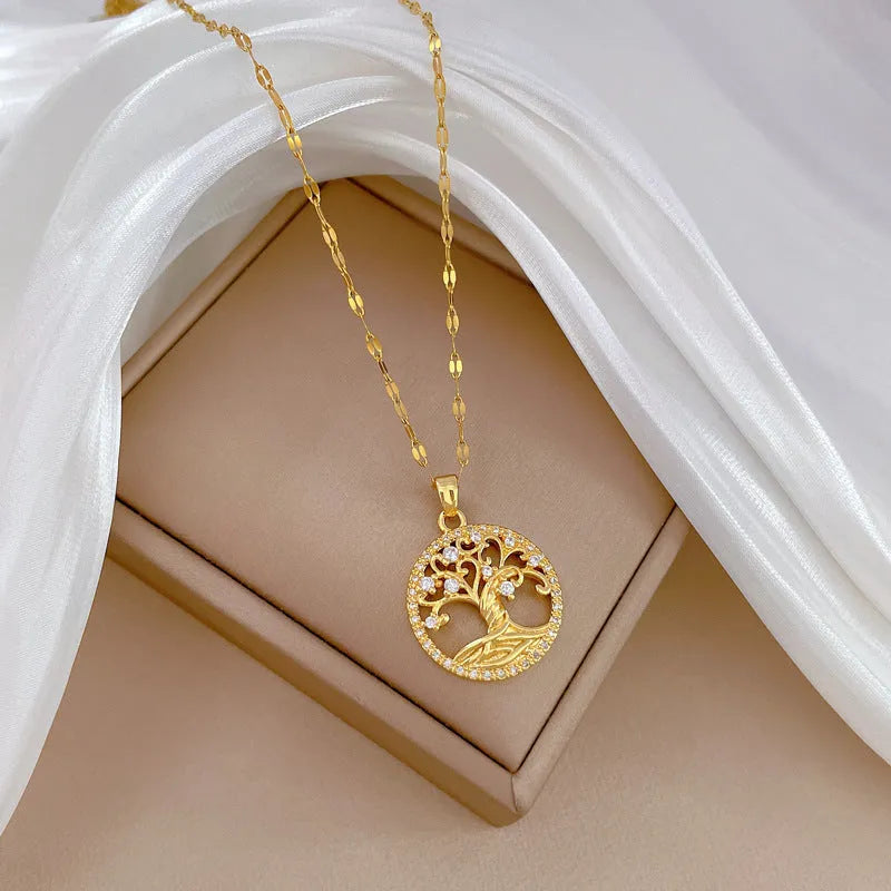 Gold-plated adjustable necklace with cross pendant showing mother of pearl inlay and rhinestone lucky tree design