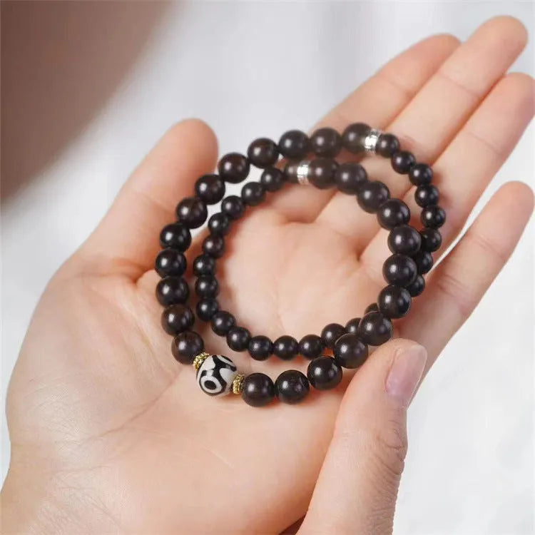 Ebony wood bracelet with 8mm beads showing two circles pattern, unisex design