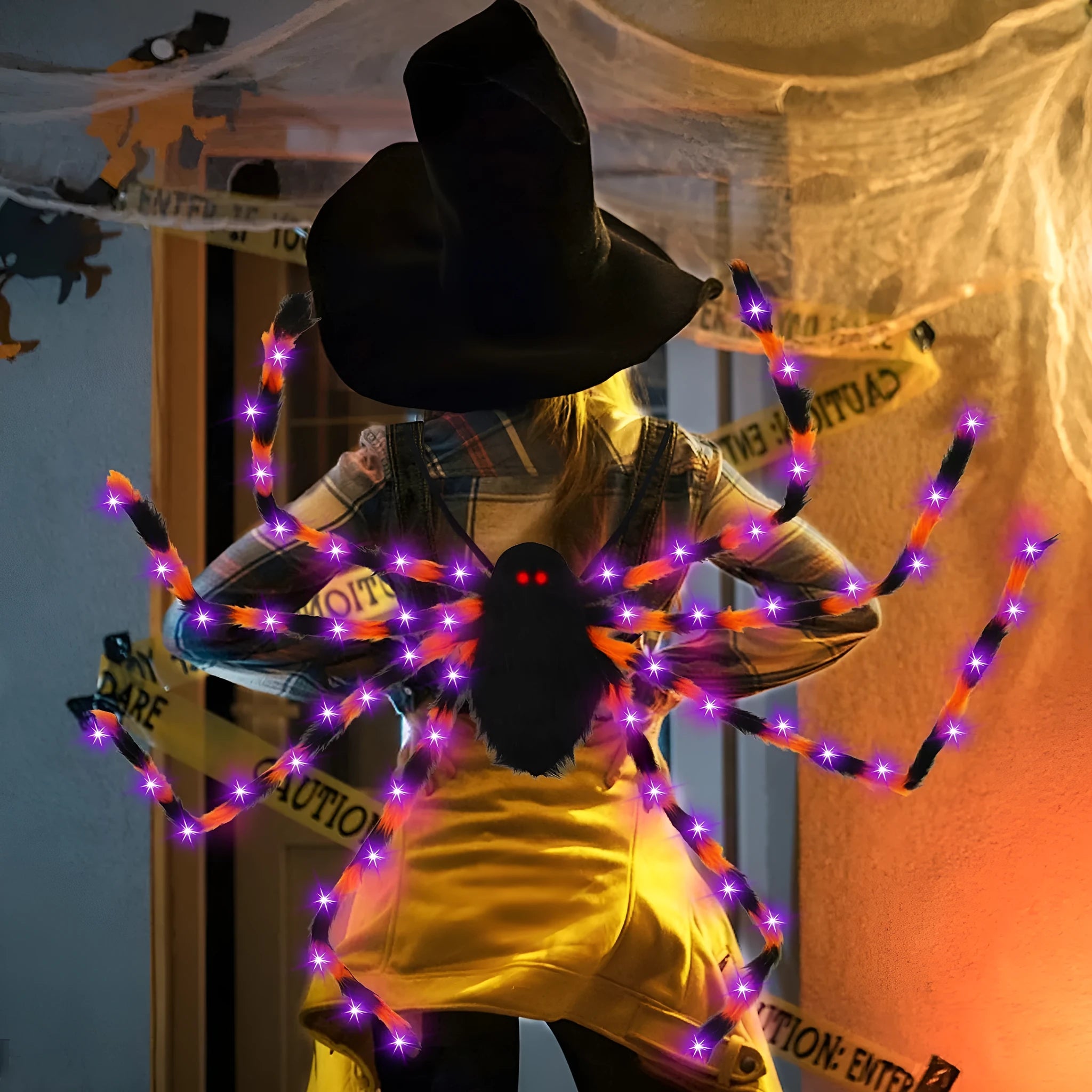 Halloween spider plush backpack with LED lights in orange purple colour, showing glow effect and backpack straps
