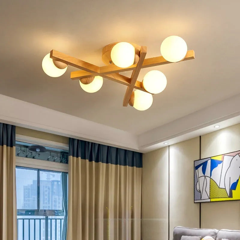 Modern wooden finish ceiling light with three adjustable lamp heads in a neutral white colour.