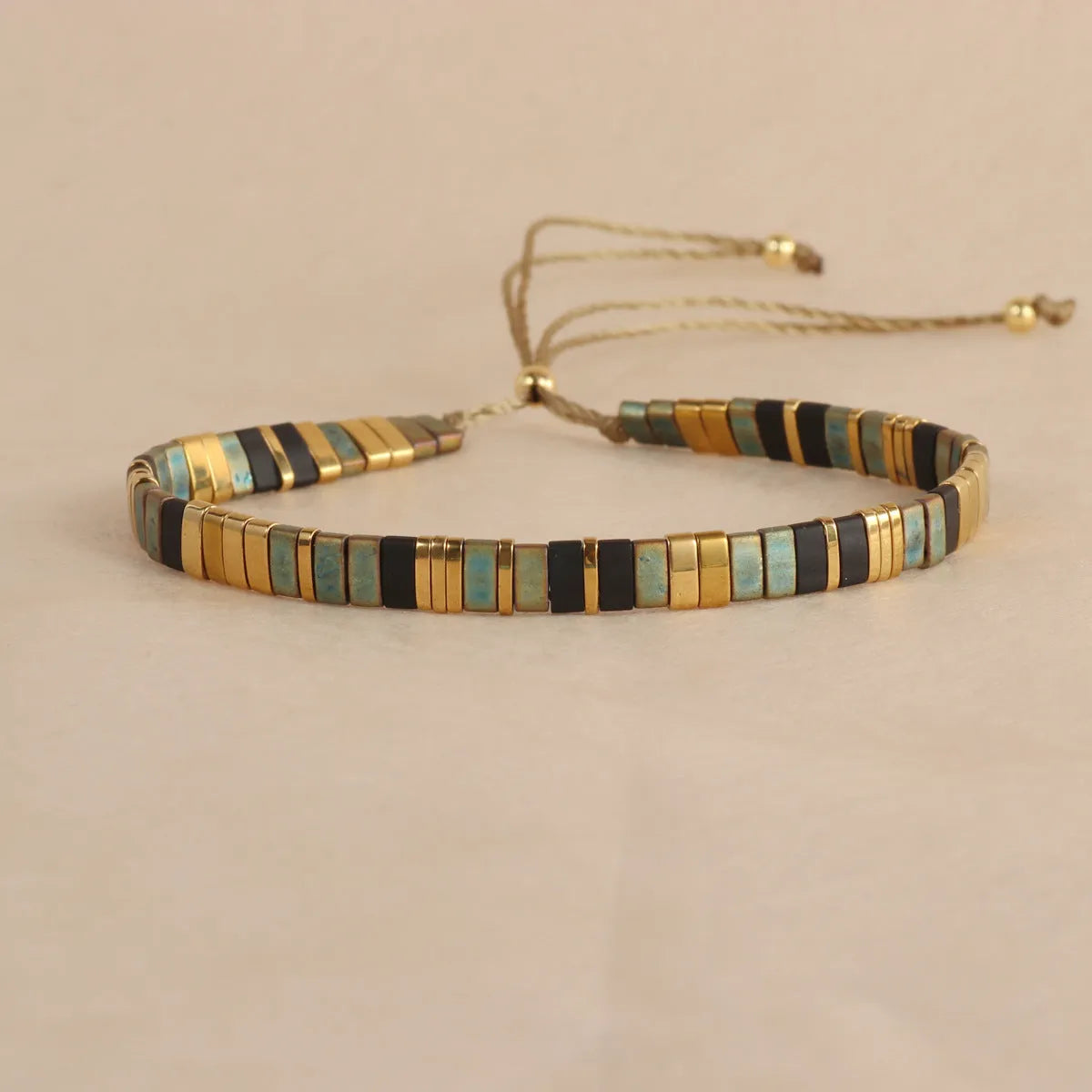 Geometric round glass bead bracelet in milky white, black, green, blue, or red.