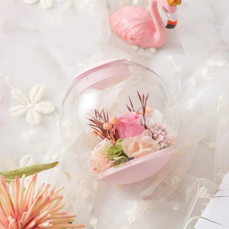 Pink preserved rose decorative ornament with optional Bluetooth-enabled base for playing music