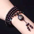 Zambia rosewood DIY bead bracelet with flat lotus pendant ornament on wooden surface