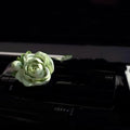 Solid gypsum car air freshener diffuser in air vent with jasmine fragrance oil.