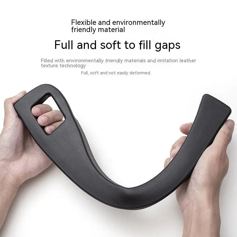 Black plastic car seat gap storage organiser box with handle inserted between car seat and centre console.