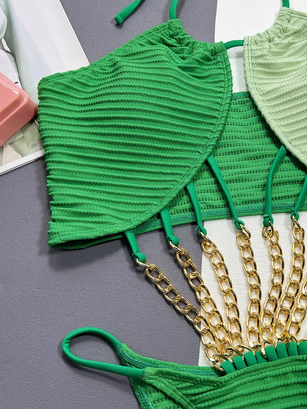 Green women's one-piece swimsuit with a hollow sexy design on a mannequin.