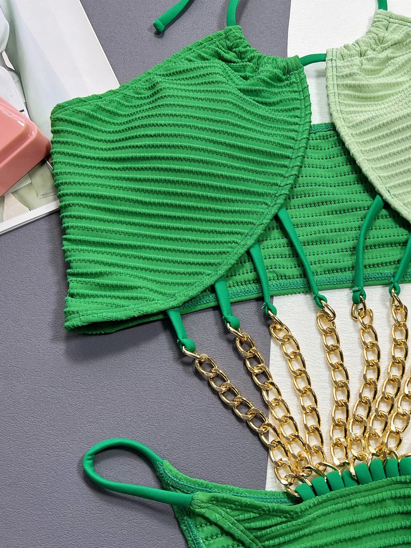 Green women's one-piece swimsuit with a hollow sexy design on a mannequin.