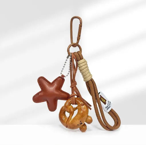 Handmade soda bread handbag pendant with brown star details and carrying strap