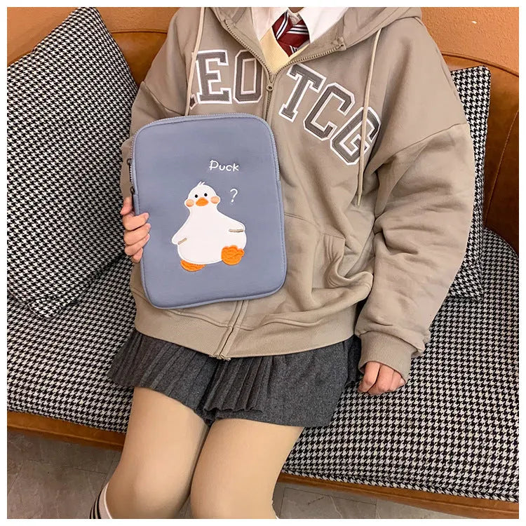 Blue cotton tablet case with embroidered cartoon duck design, zipper closed.