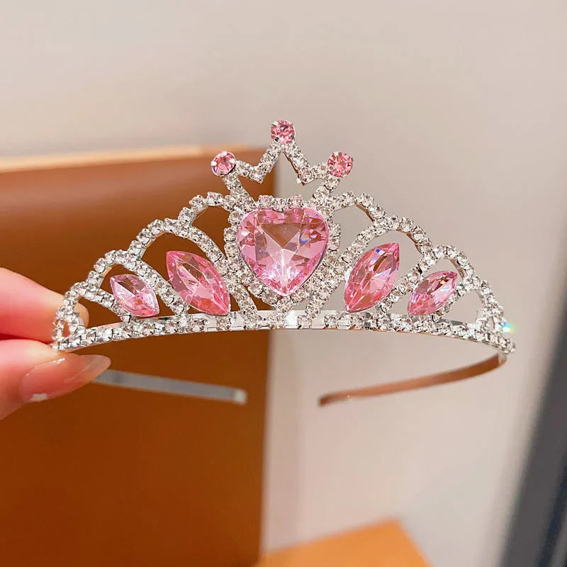 Children's electroplated alloy metal headband with crown shape and crystal decoration in pink, blue, or purple.
