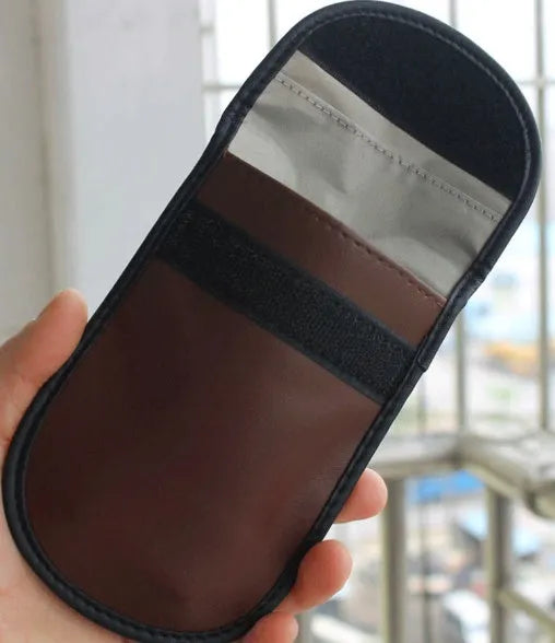 Black microfiber Faraday cage pouch for blocking car key fob and credit card signals.