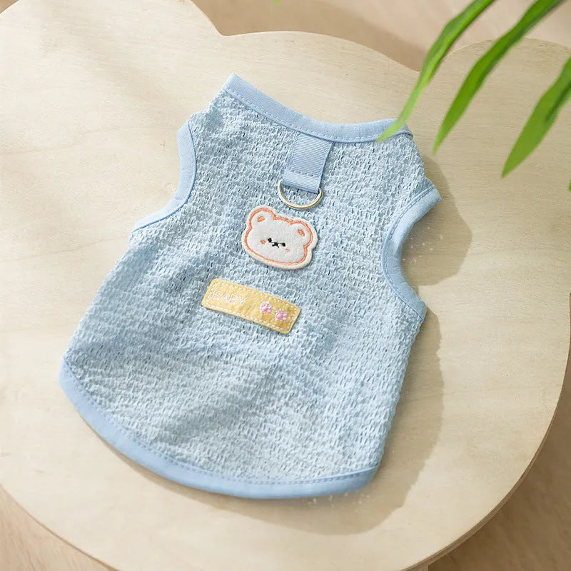 Hollowed-out cat clothes with bear patch in blue, green, yellow colours showing knitted fabric texture