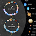 Two natural stone beaded bracelets showing zodiac sign designs on a wooden surface.