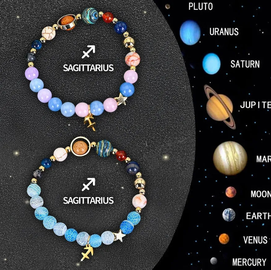 Two natural stone beaded bracelets showing zodiac sign designs on a wooden surface.