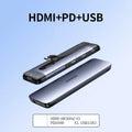 Black USB-C docking station hub showing multiple ports including HDMI, USB, and ethernet, with a short connecting cable.