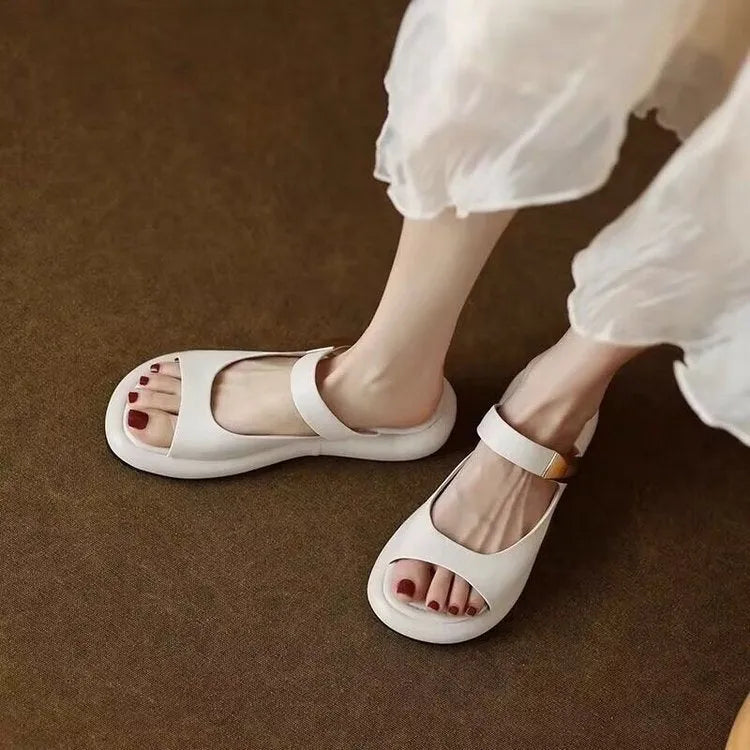 Women's apricot and white peep toe flat platform sandals with a rubber sole.