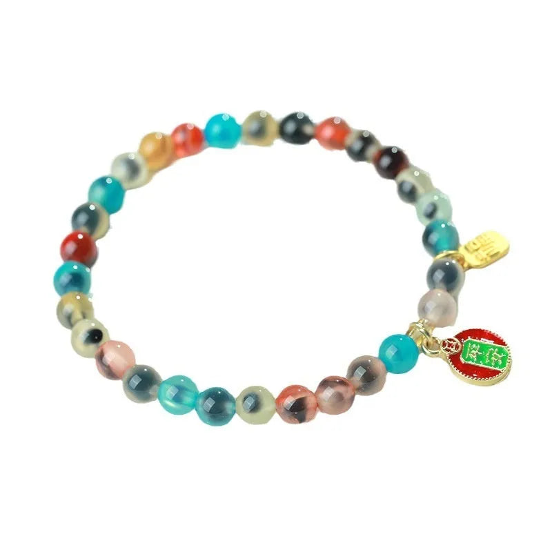 Handmade women's agate bracelet with coloured glaze copper coins in a snake chain, showing fu character or swallowing gold beast motifs.
