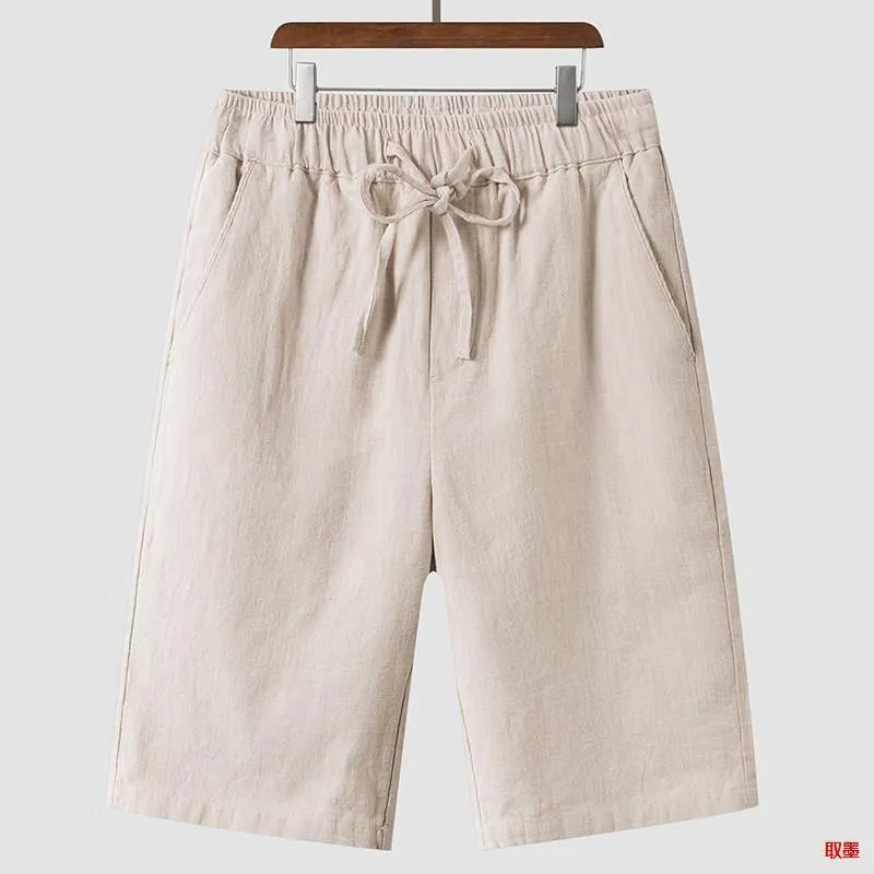 Men's loose-fit linen shorts in a cropped mid-length style with an elastic waistband.