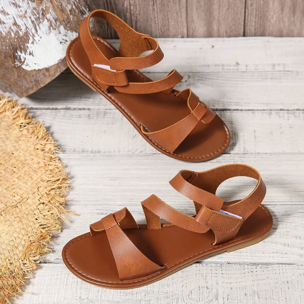 Women's flat sandals with adjustable Velcro straps in black, brown, or colourful designs