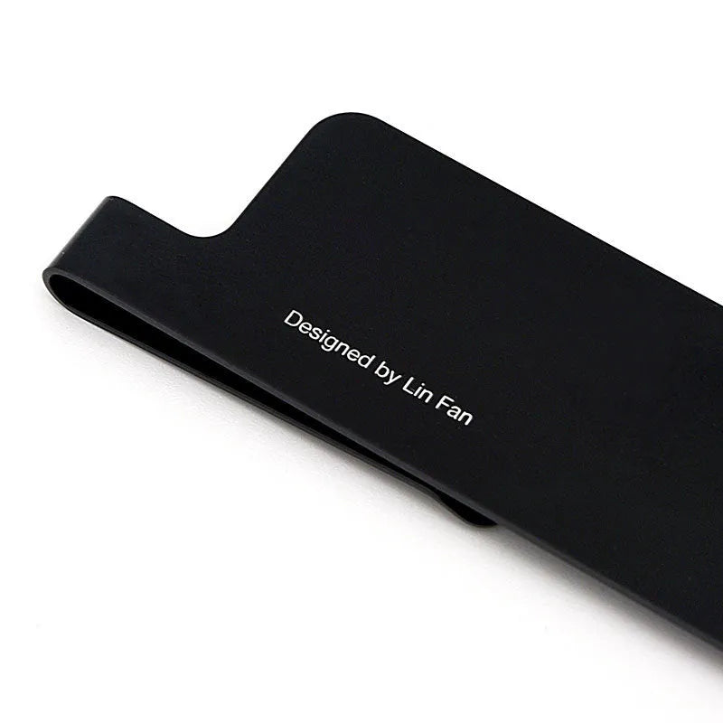 RUMA black and silver aluminium bookmark ruler showing 15cm laser-engraved scale.