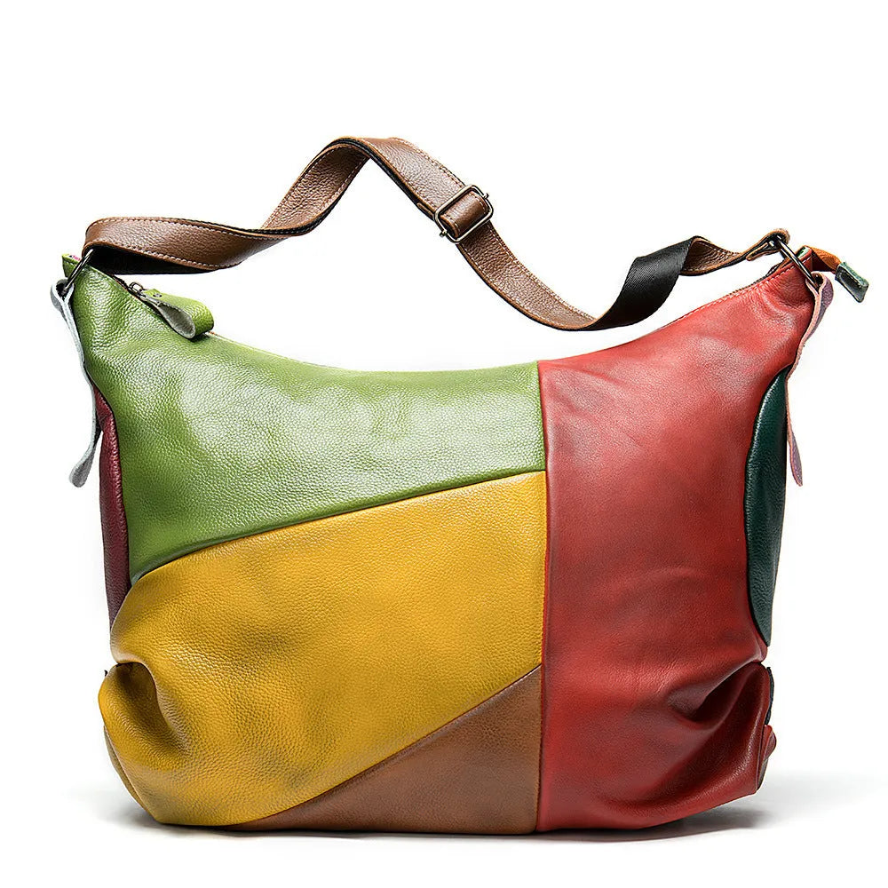 Brown cowhide leather travel shoulder bag with stitching detail, shown with a laptop and tablet inside.