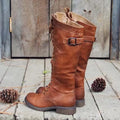 Women's black high leg boots with a round toe and low chunky heel on a plain background
