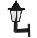 Black hexagonal solar-powered outdoor wall light with a visible solar panel and LED.