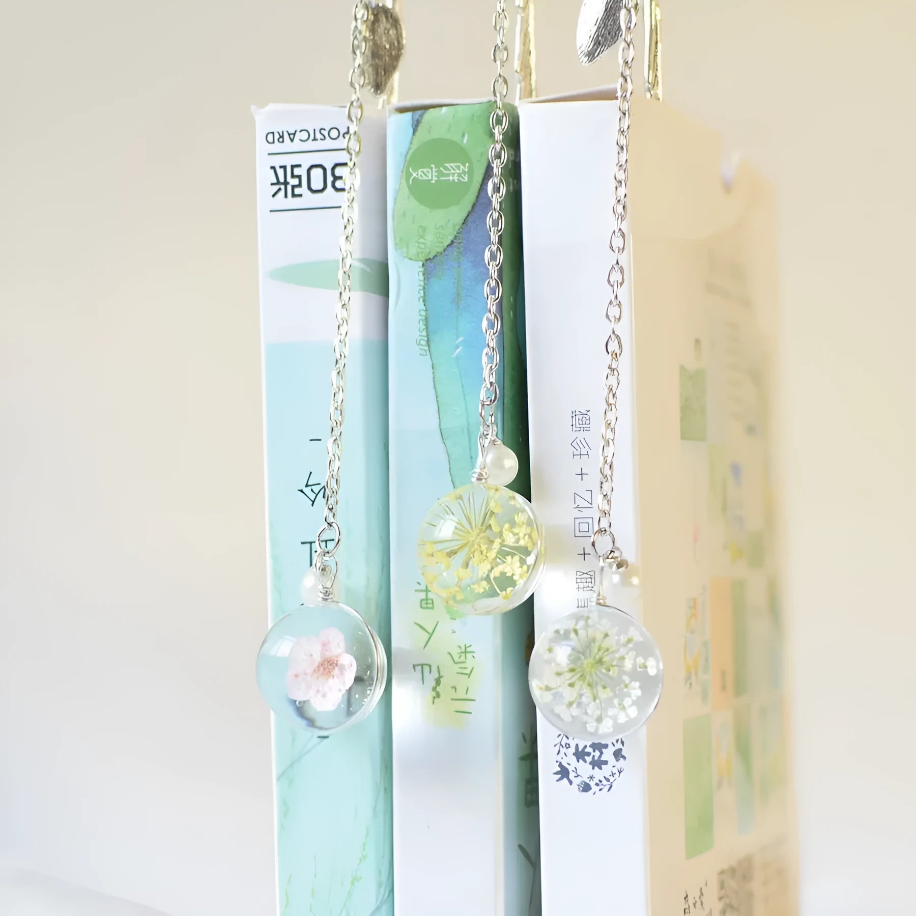 Dried flower specimen encased in metal alloy bookmark pendant measuring 12cm by 2cm