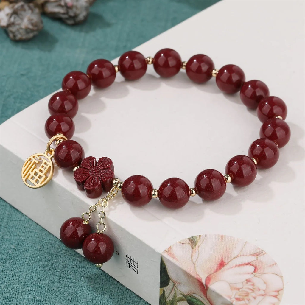 Women's cinnabar national style bracelet with purple gold sand finish and Fu character peach blossom charm