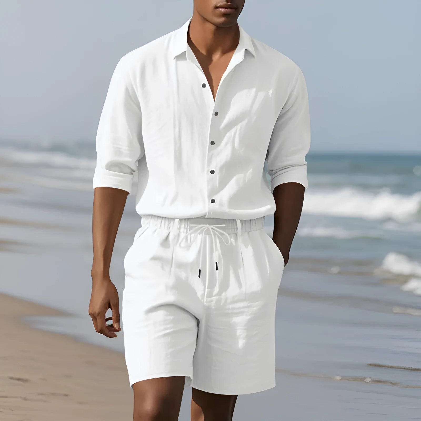Linen long sleeve shirt and matching shorts beach set in light blue, laid flat.