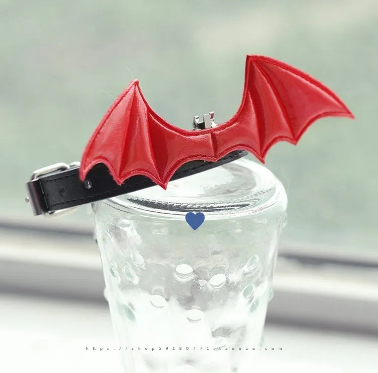 Small dog collar with devil wings and bell detail in patent leather satin material