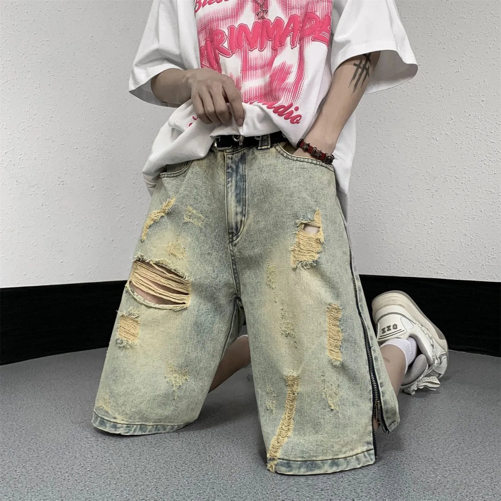 Blue retro denim shorts for men with ripped detail, loose five-points fit, and button fly closure.