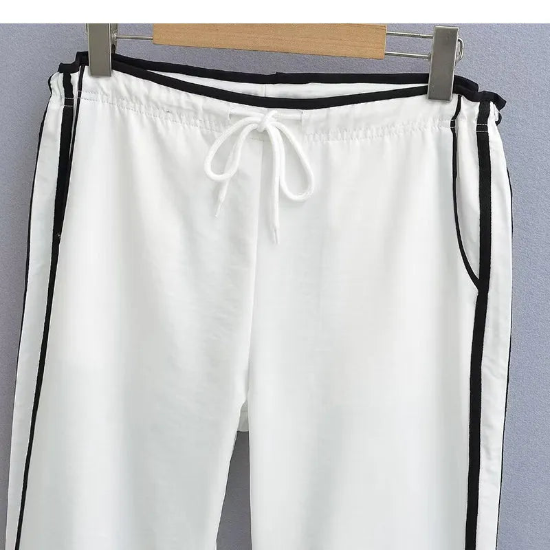 Women's navy blue straight leg trousers with a low waist and slimming drape.