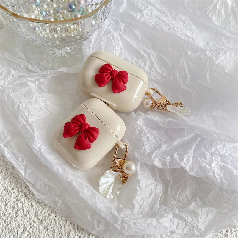 Beige red bow shell TPU protective case cover for AirPods showing clamshell design