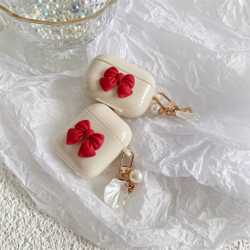 Beige red bow shell TPU protective case cover for AirPods showing clamshell design
