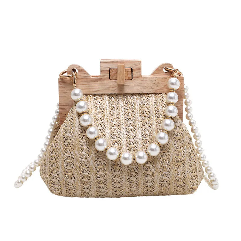 Women's woven straw shoulder bag with pearl chain detailing in horizontal square shape showing internal compartments