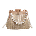 Women's woven straw shoulder bag with pearl chain detailing in horizontal square shape showing internal compartments