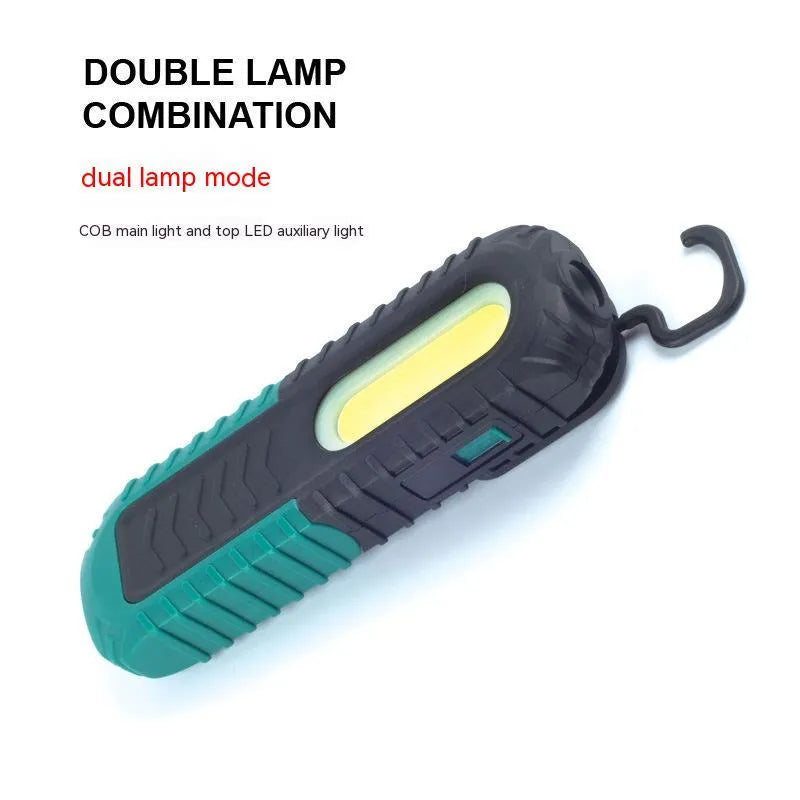 Black and green auto repair work light with USB charging port and clear lens