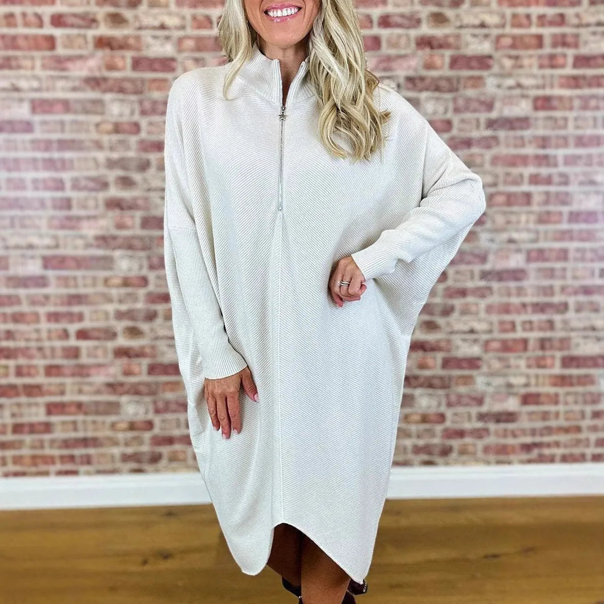 Women's solid colour loose knitted dress with raglan sleeves and a zipper detail.