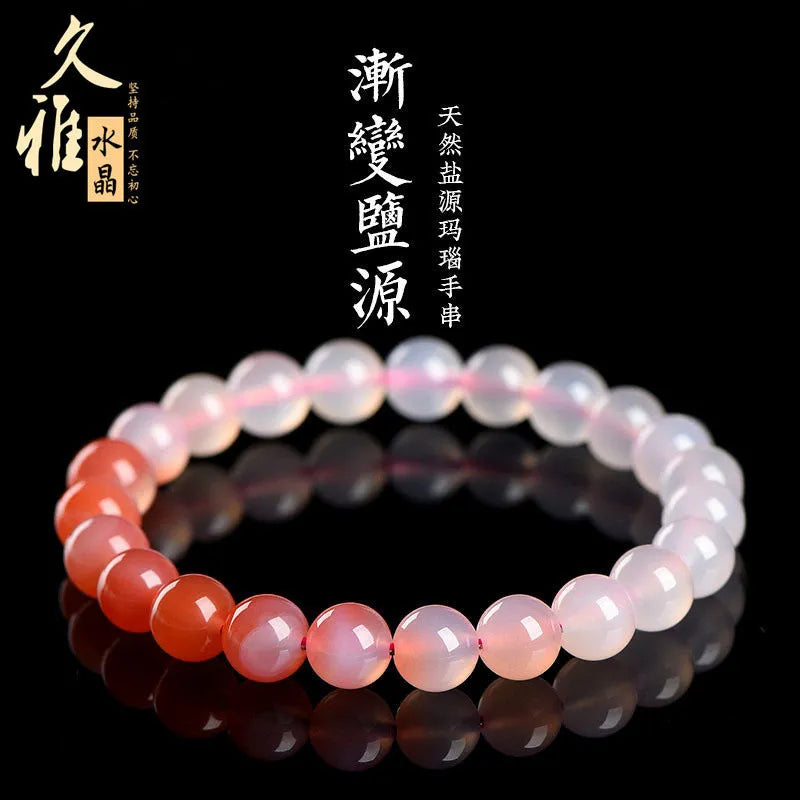 Natural gradient Yanyuan agate bracelet with geometry-shaped beads on a wrist.