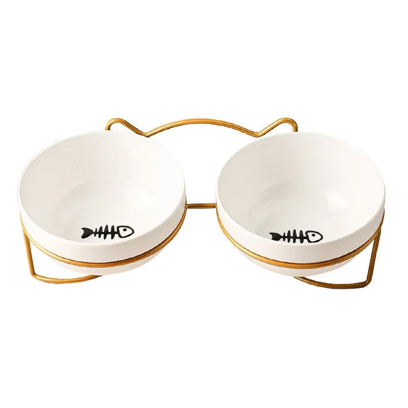 White ceramic pet bowl with cat footprints design in a black iron frame.