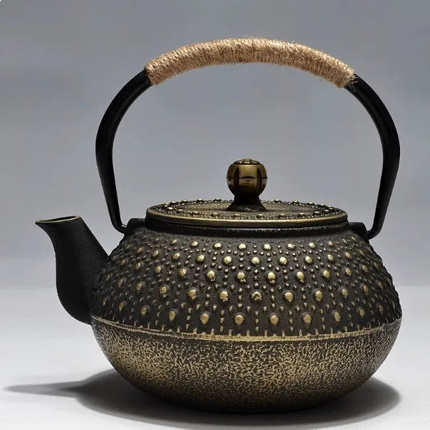 Japanese cast iron teapot in black with Peony pattern, showing lid, handle, and spout.