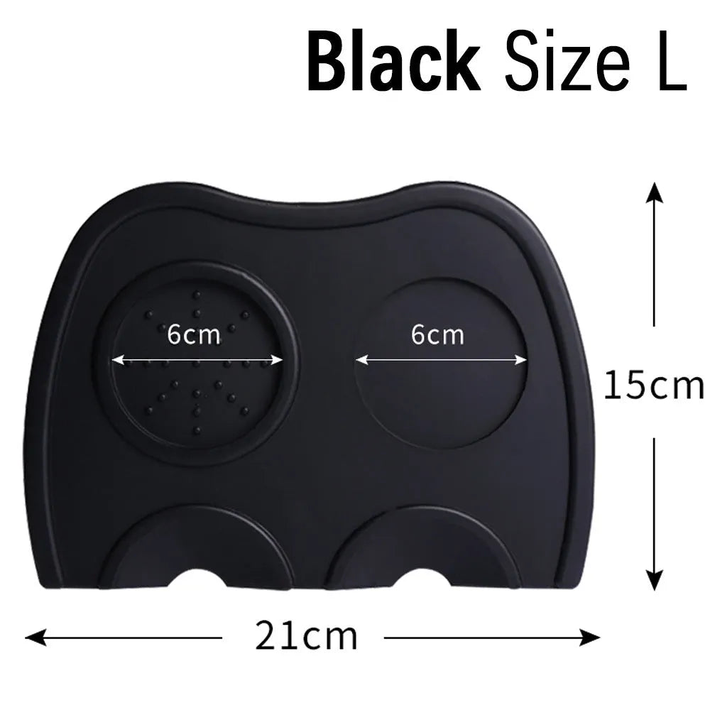 Black silicone pad coffee tamper with stainless steel base next to a red version on a counter.