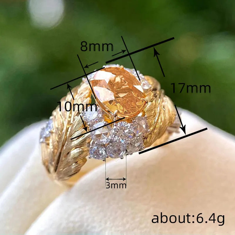 Gold women's feather ring with embossed geometric design and yellow zircon stone