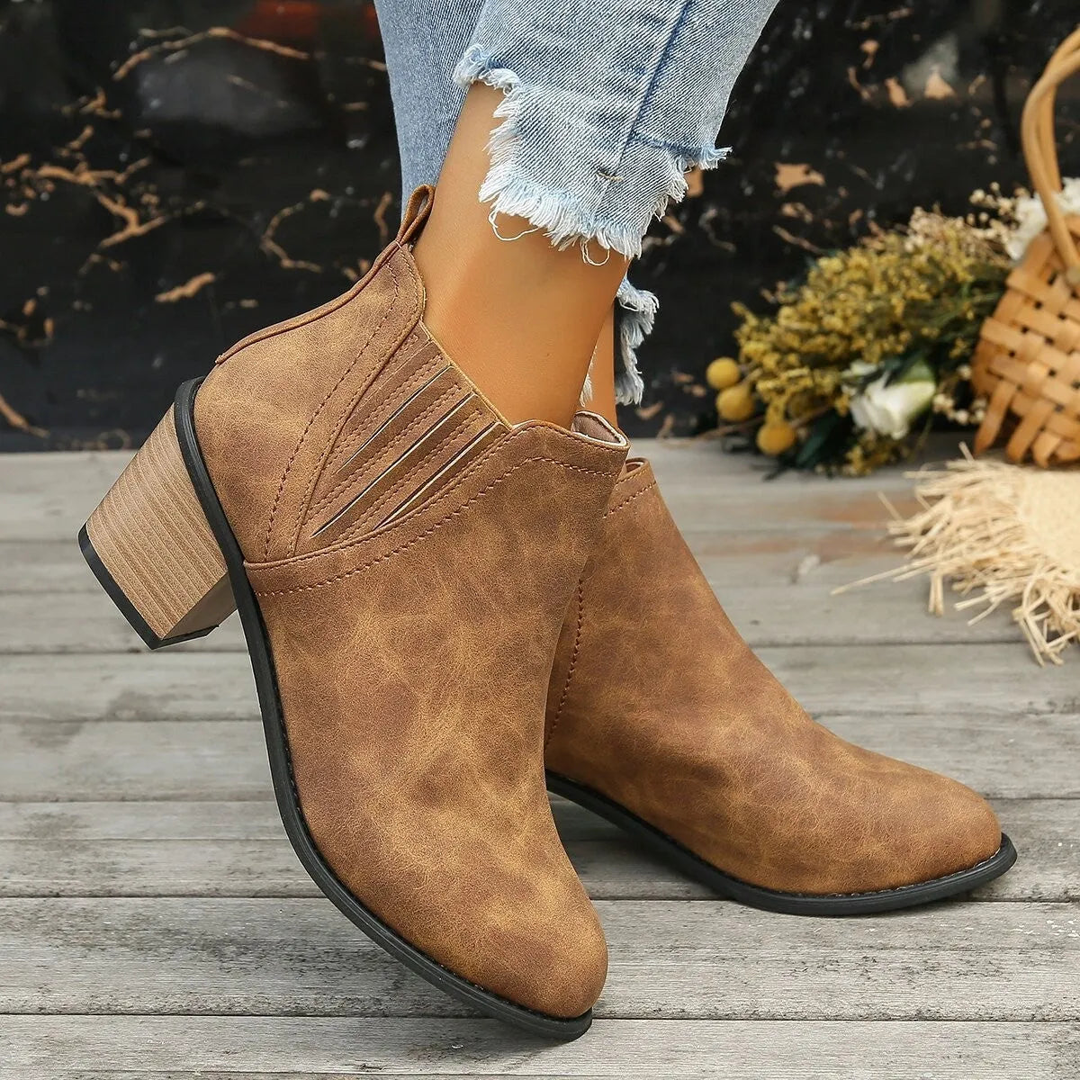 Women's black ankle boots with pointed toe and thick square heel on a rubber sole