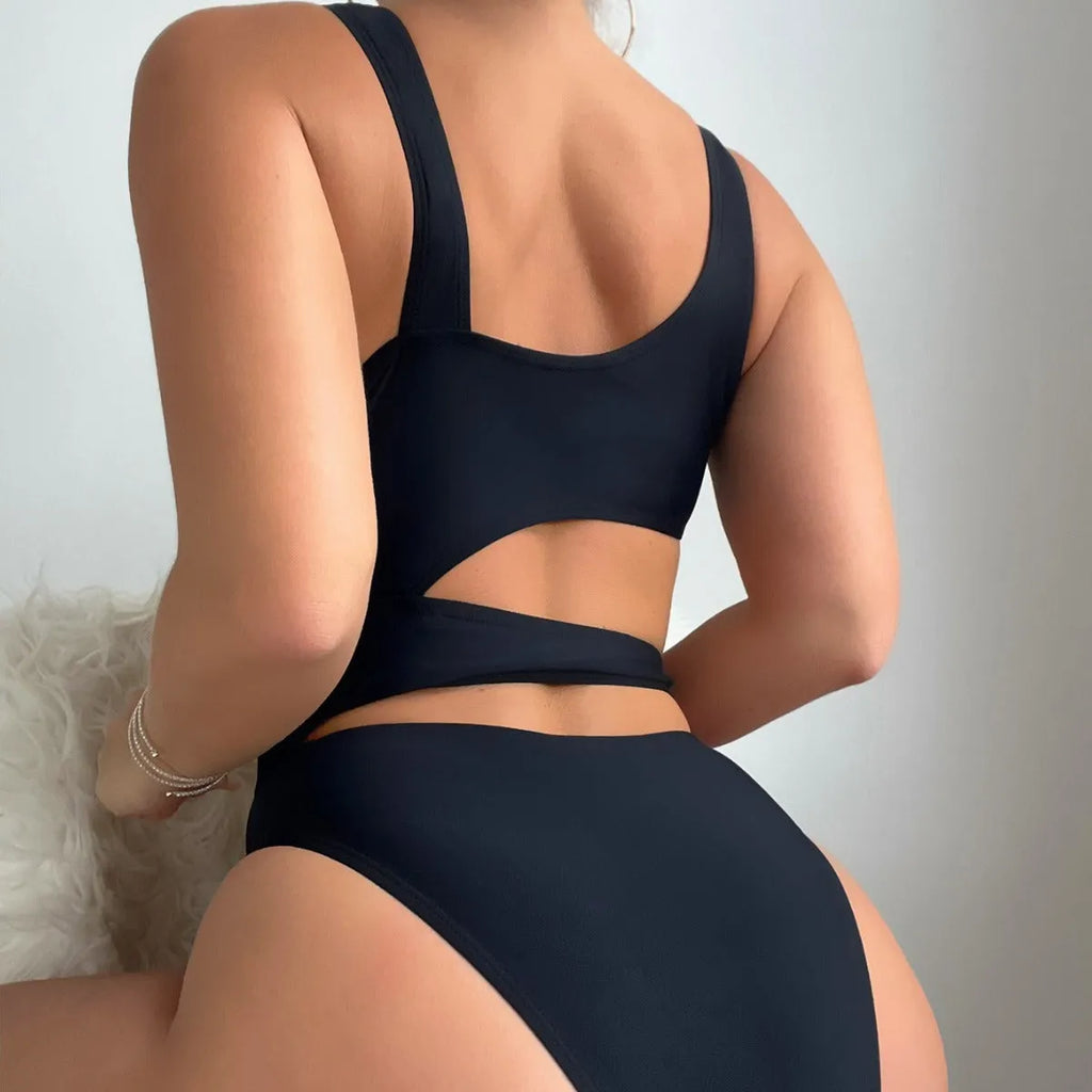 Black solid colour women's one-piece swimsuit with high-cut legs and a hollow back design.