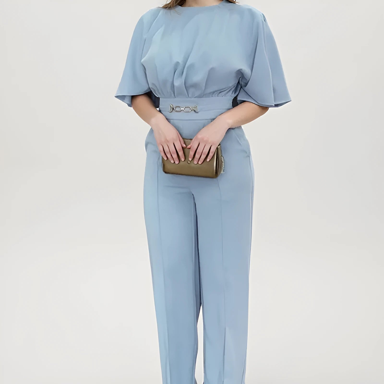 Blue two-piece polyester suit with long sleeves and trousers on a hanger