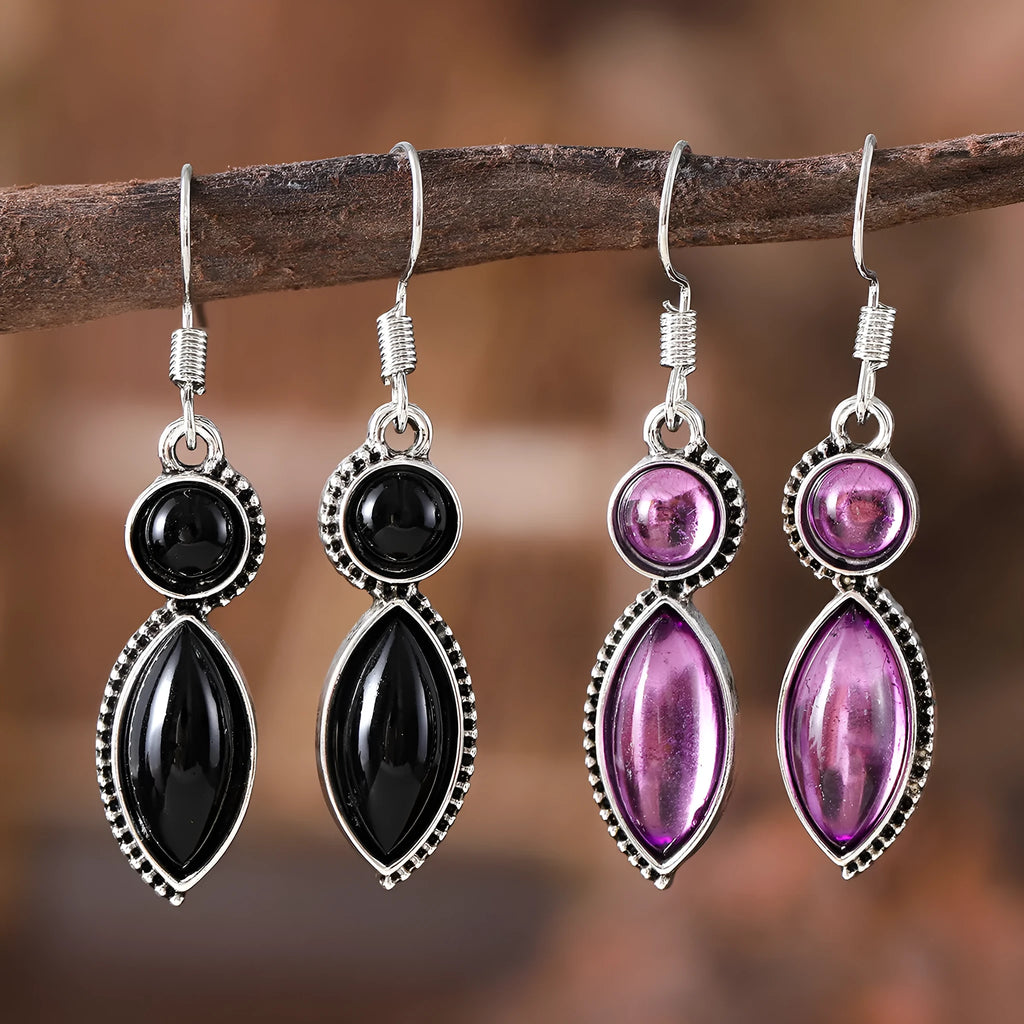 A pair of geometric vintage pendant earrings in black and purple colours with a bohemian style.
