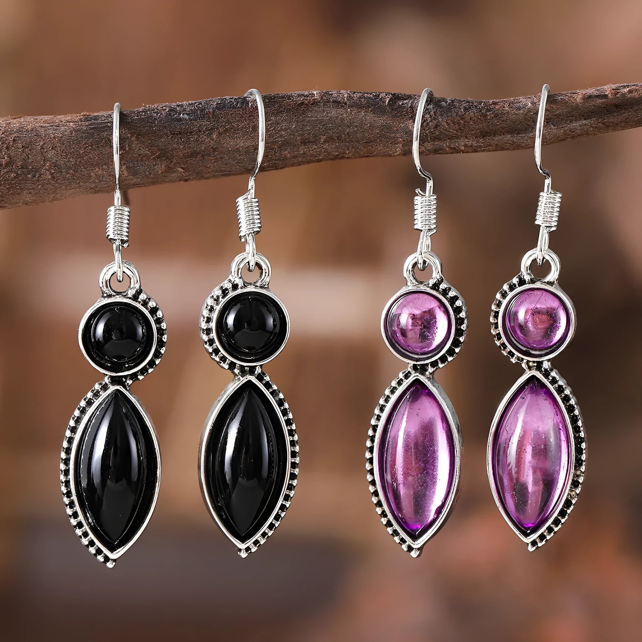 A pair of geometric vintage pendant earrings in black and purple colours with a bohemian style.